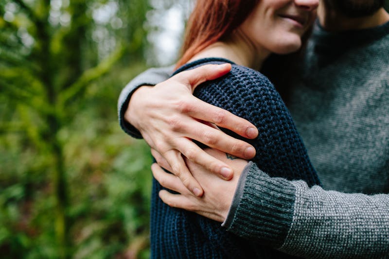 Couple embraces in the woods