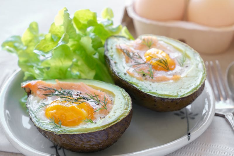 Baked smoked salmon, egg in avocado, ketogenic keto low carb diet food