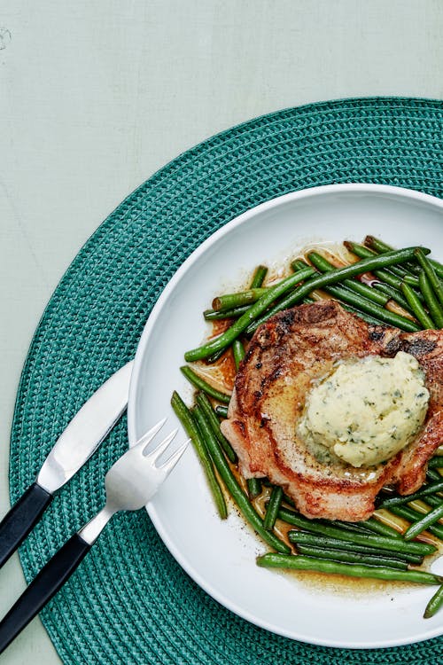 Pork chops with green beans and garlic butter