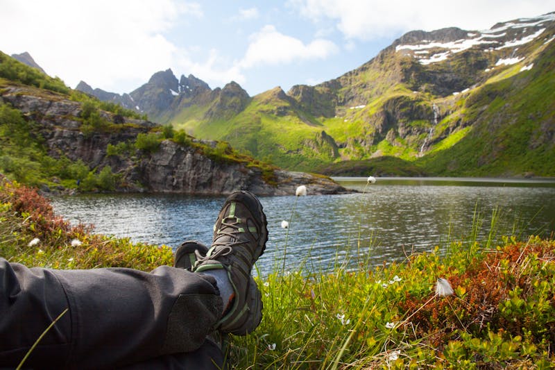 Hiker resting near mountain lake