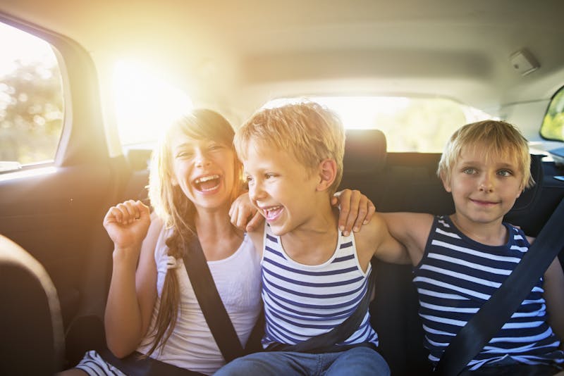 Kids having fun in car on a road trip