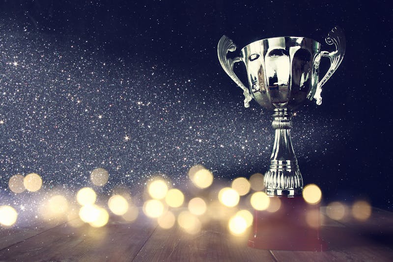 low key image of trophy over wooden table