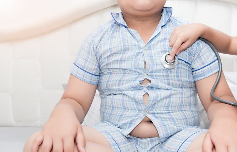 doctor check heart by stethoscope to obese asian boy