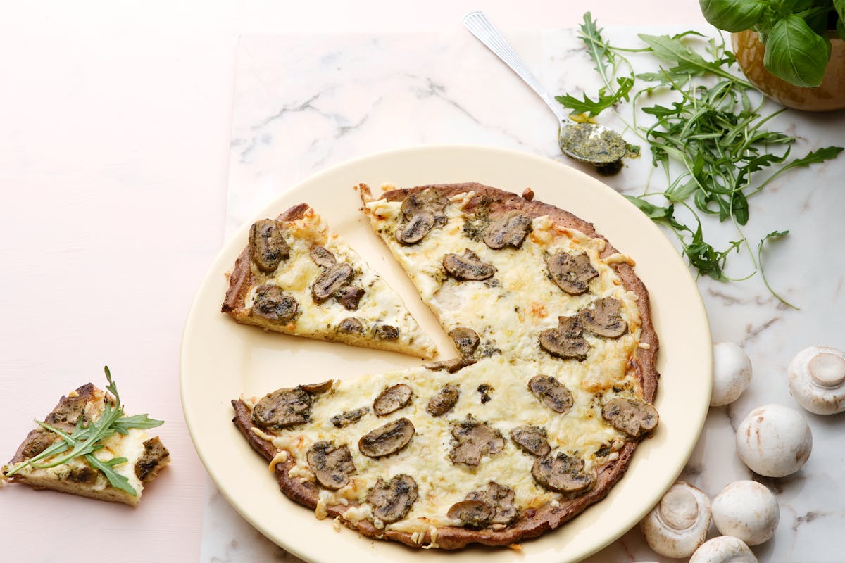 Keto white pizza with mushrooms and pesto