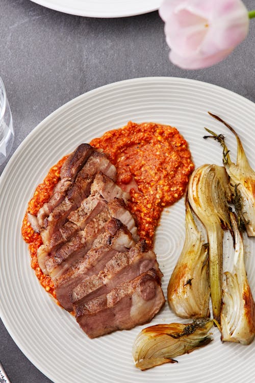 Pork shoulder with roasted fennel and Romesco sauce