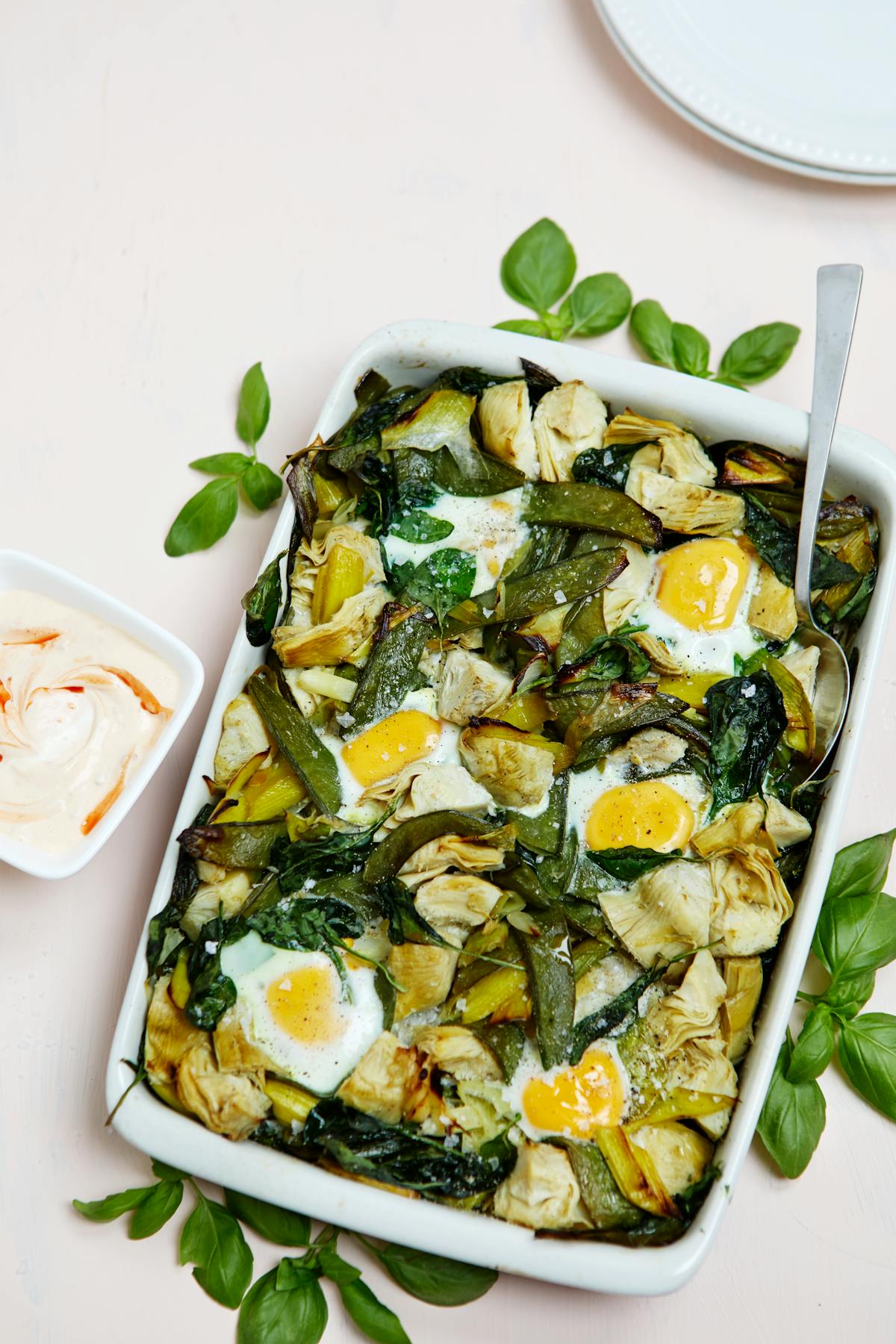 Baked eggs with veggies and spicy yogurt sauce