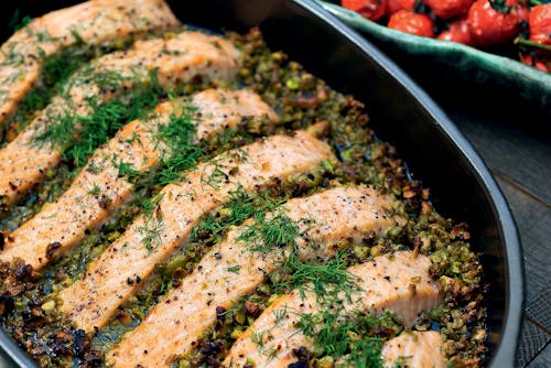 Salmon with olive-pistachio tapenade and tomatoes