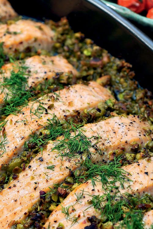 Salmon with olive-pistachio tapenade and tomatoes