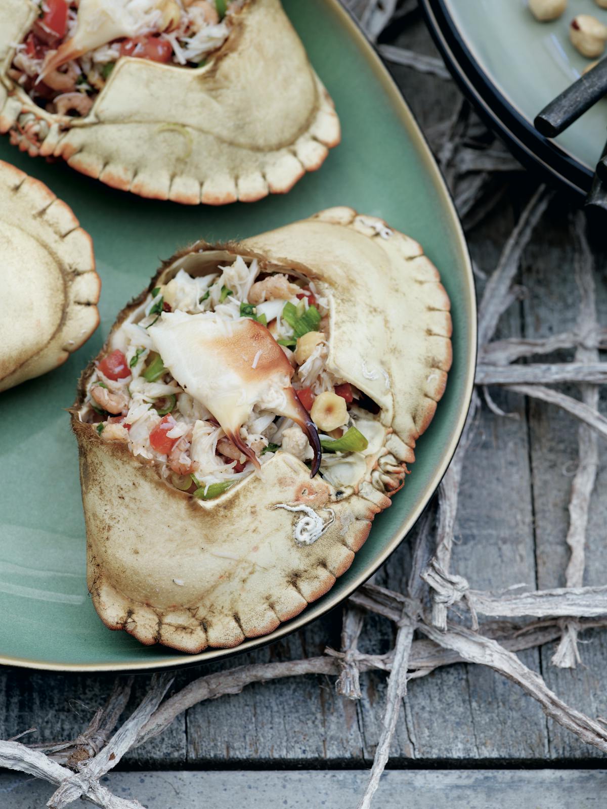 Crabs stuffed with tomatoes, basil and hazelnuts