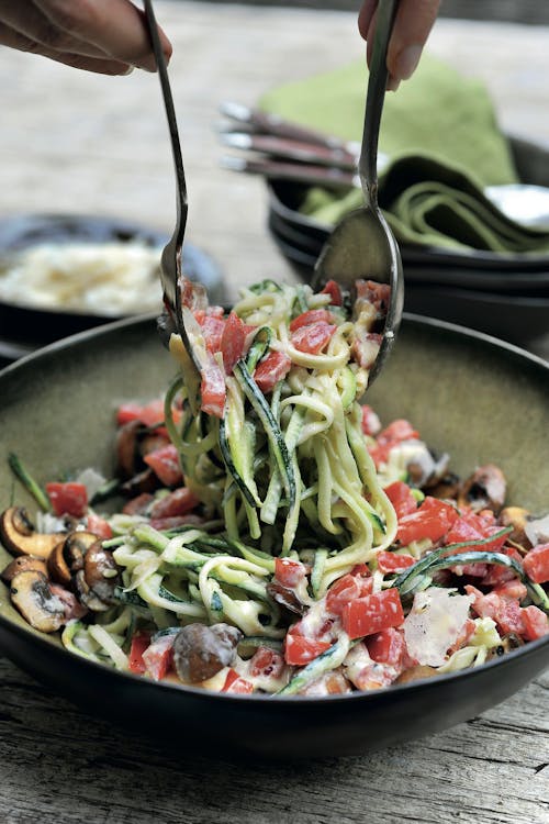 Zucchini noodles with tomatoes, mushrooms and Parmesan sauce