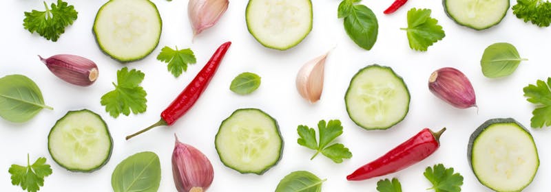 Vegetable and spices isolated on white background, top view. Wallpaper abstract composition of vegetables.