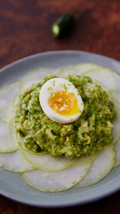 Shaved kohlrabi with smashed avocado, anchovies and soft-boiled eggs