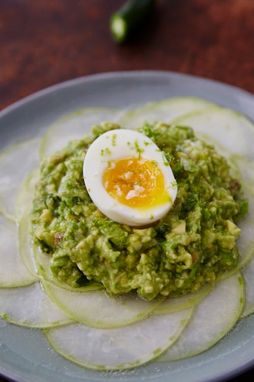 Shaved kohlrabi with smashed avocado, anchovies and soft-boiled eggs