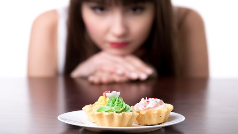 Dieting woman craving for cake