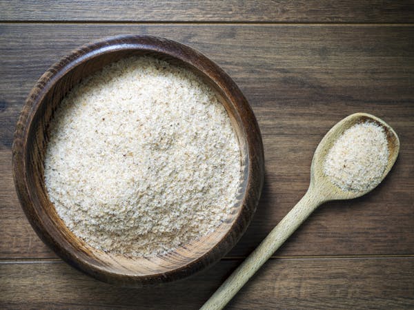 Psyllium husk (ispaghula) on a ladle and in a bowl