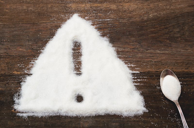 Sign of warning attention made of granulated sugar