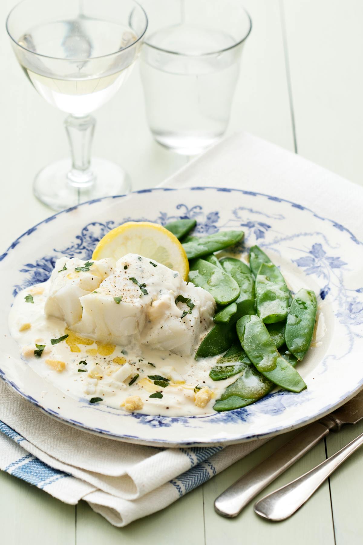 Fish with creamy egg sauce and sugar snaps
