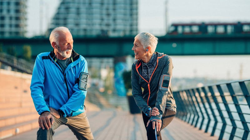 Senior couple stretching outdoors