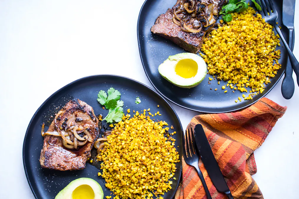 Pan-seared steak with yellow cauliflower rice