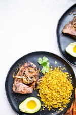 Pan-seared steak with yellow cauliflower rice