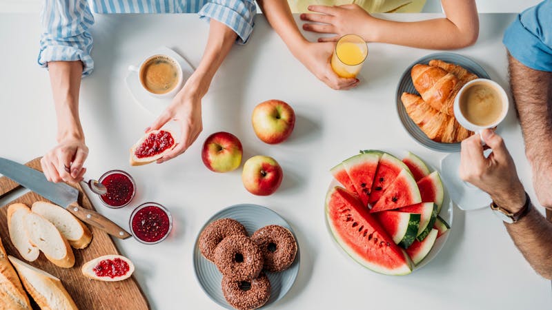 cropped shot of young family having breakfast together