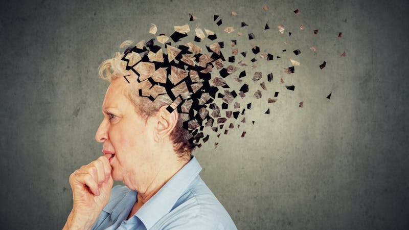 Senior woman losing parts of head feeling confused as symbol of decreased mind function.
