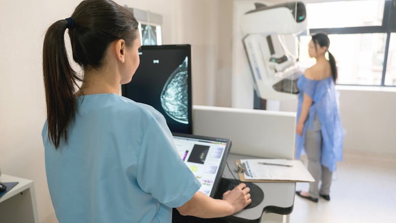 Unrecognizable nurse taking a mammogram exam to an adult patient