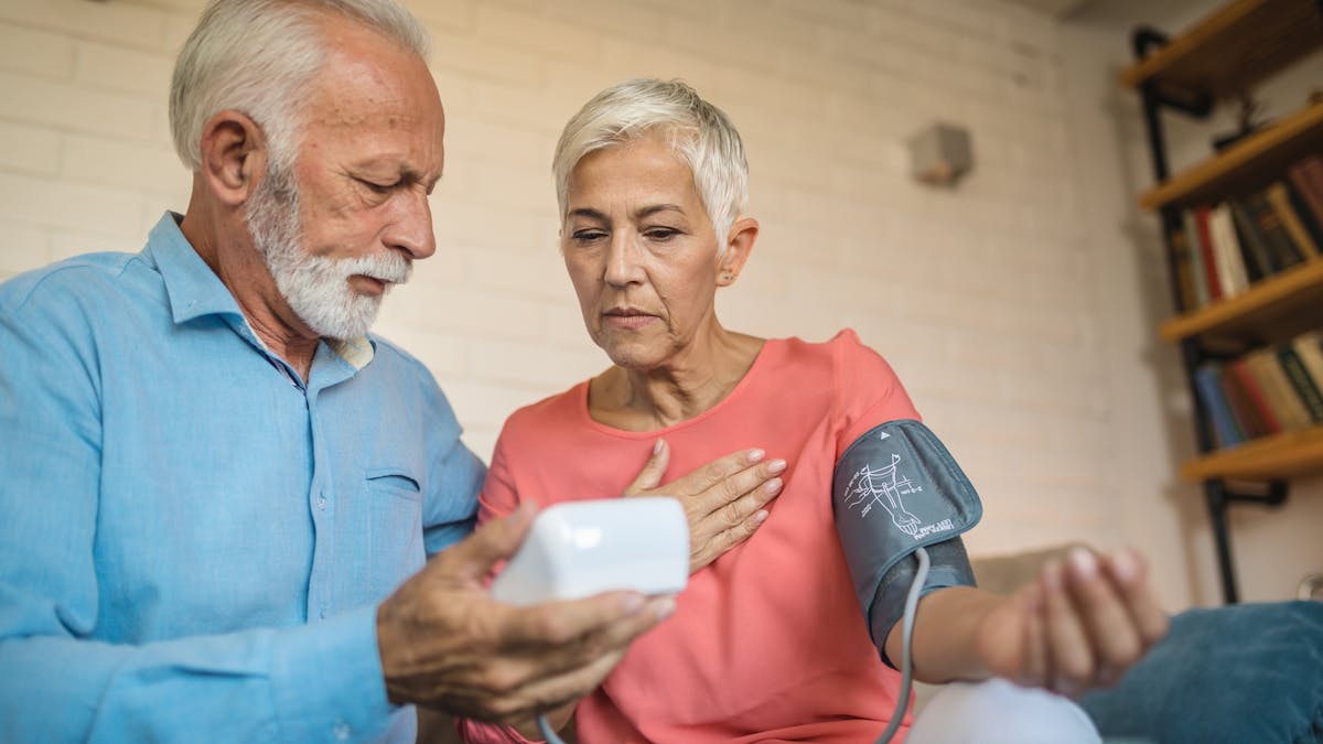 Lovely senior couple measuring blood pressure
