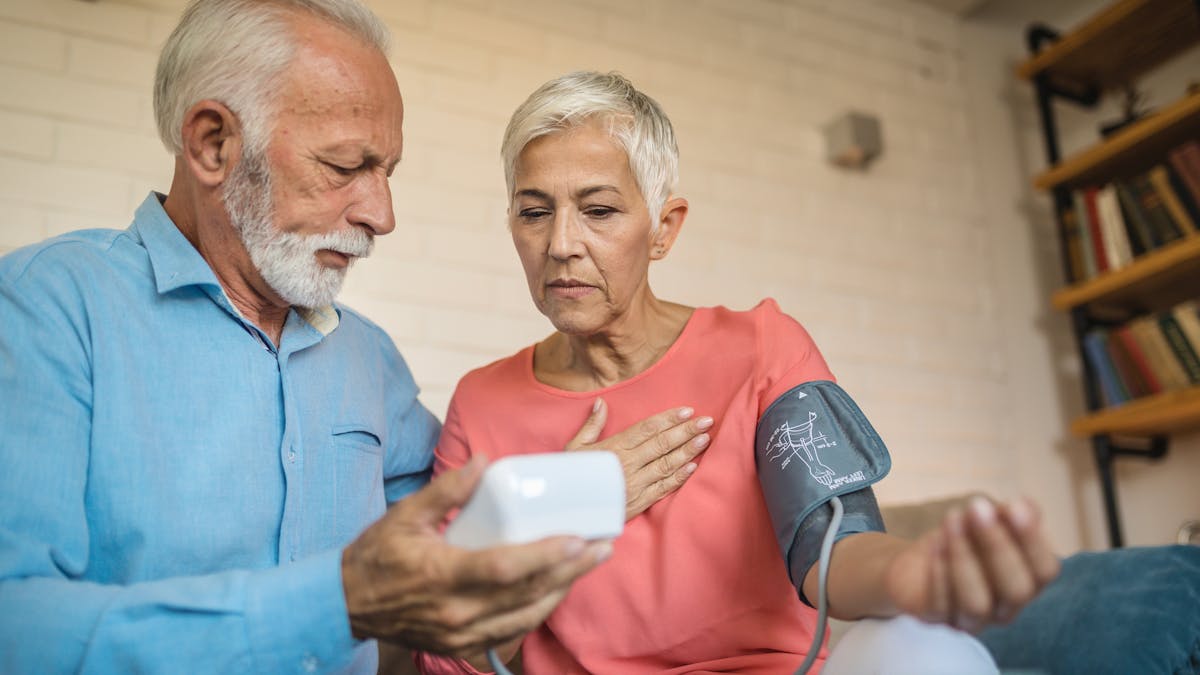 Lovely senior couple measuring blood pressure