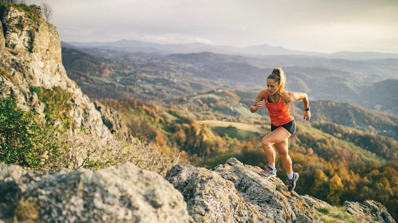 Young woman running on mountain