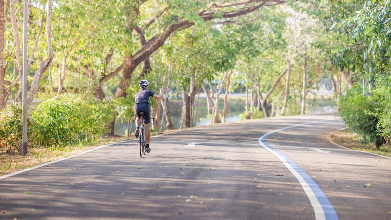 man Cyclist riding mountain bike in public park at moring