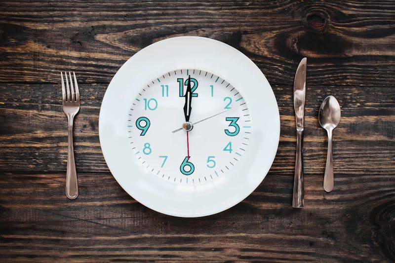 Twelve hour intermittent fasting time concept with clock on plate