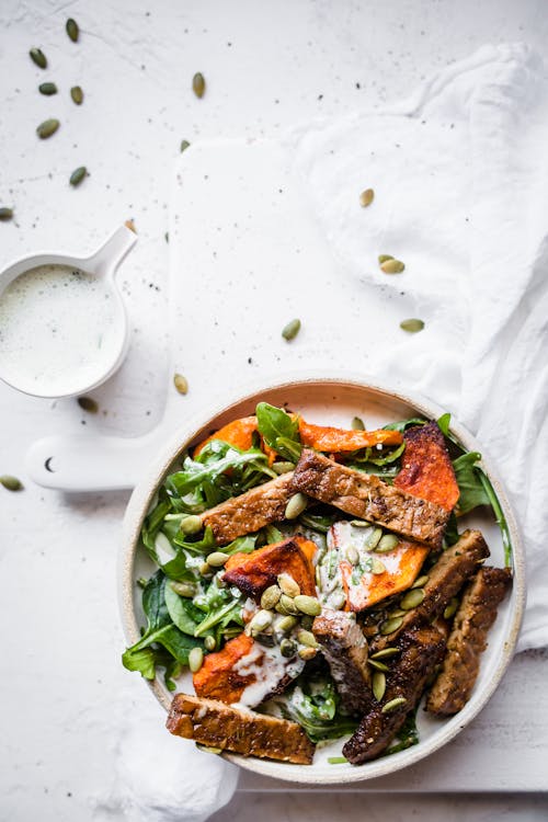 Low carb vegan tempeh pumpkin bowl with herb dressing