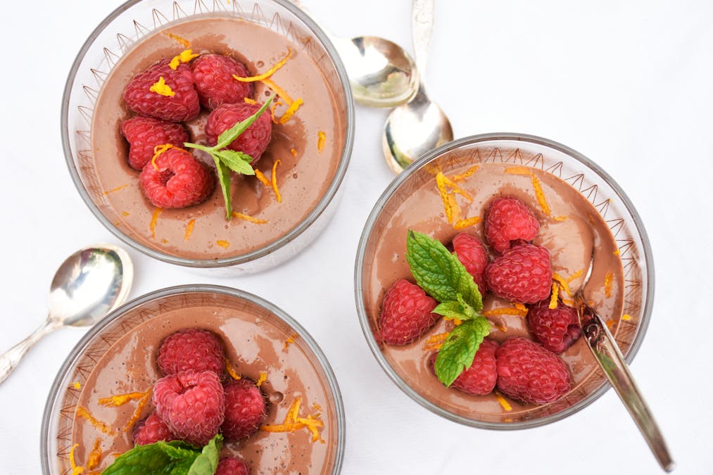 Low carb chocolate pudding with raspberries and orange zest