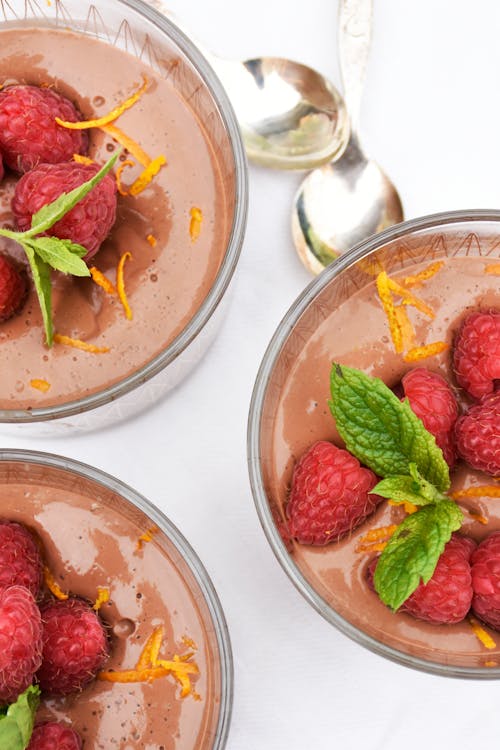Low carb chocolate pudding with raspberries and orange zest
