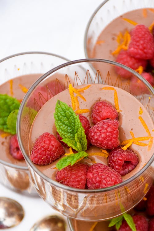 Low carb chocolate pudding with raspberries and orange zest