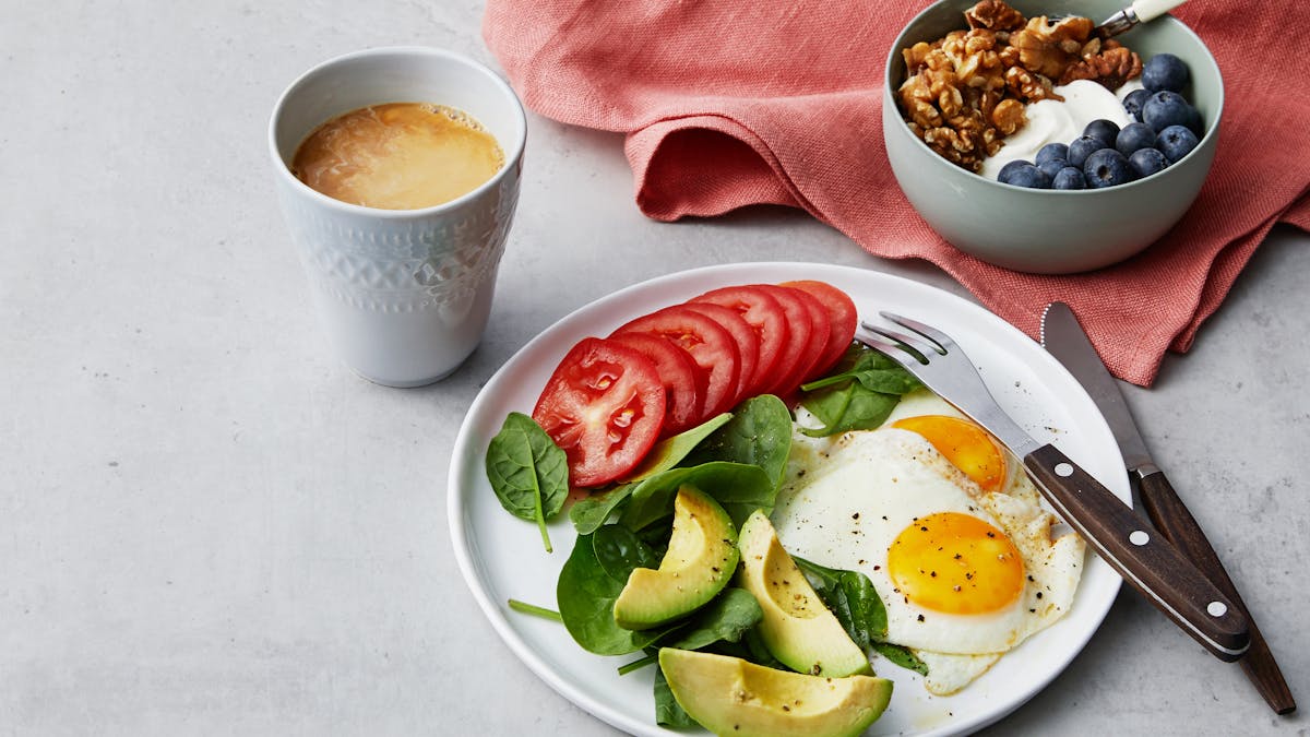 Simple liberal low carb breakfast with fried eggs and yogurt