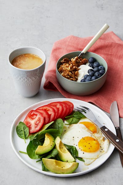 Simple liberal low-carb breakfast with fried eggs and yogurt
