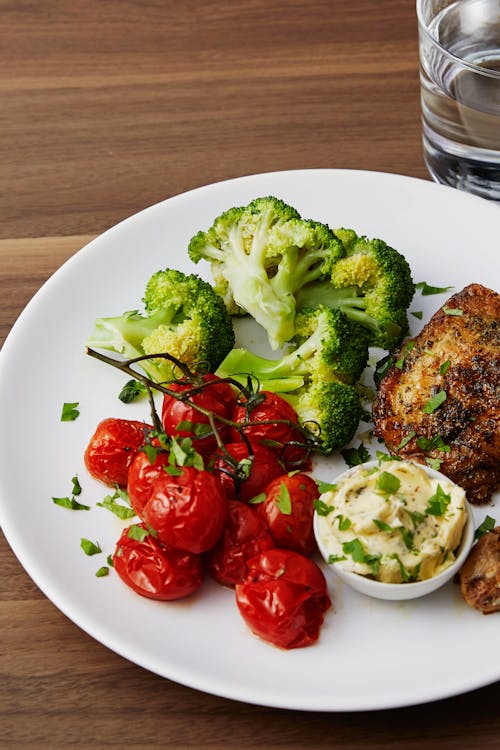 Roasted chicken legs and cherry tomatoes with garlic butter