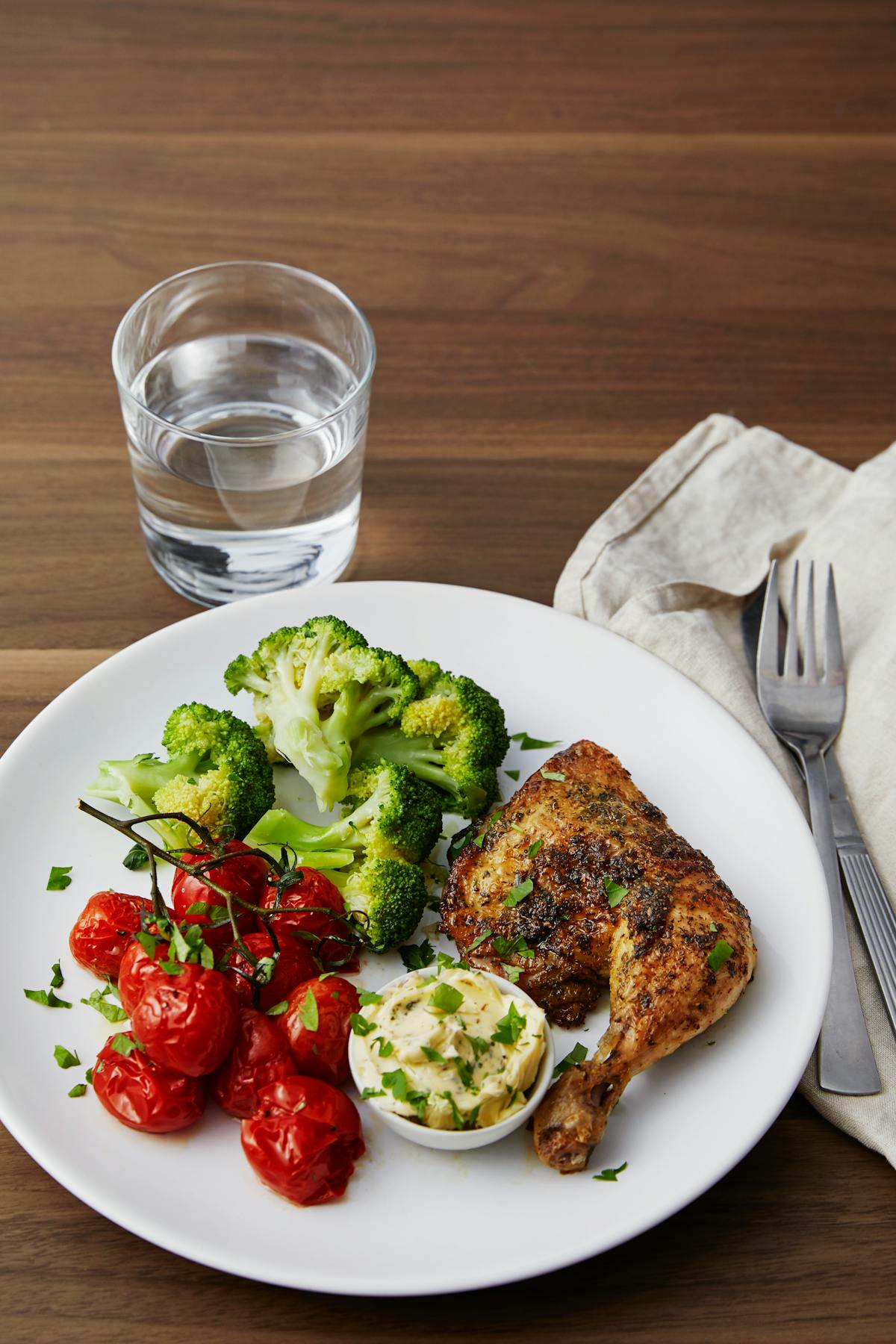 Roasted chicken legs and cherry tomatoes with garlic butter