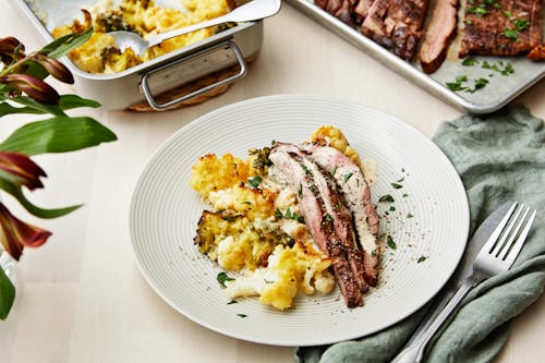 Flank steak with pepper sauce and cauliflower-broccoli gratin
