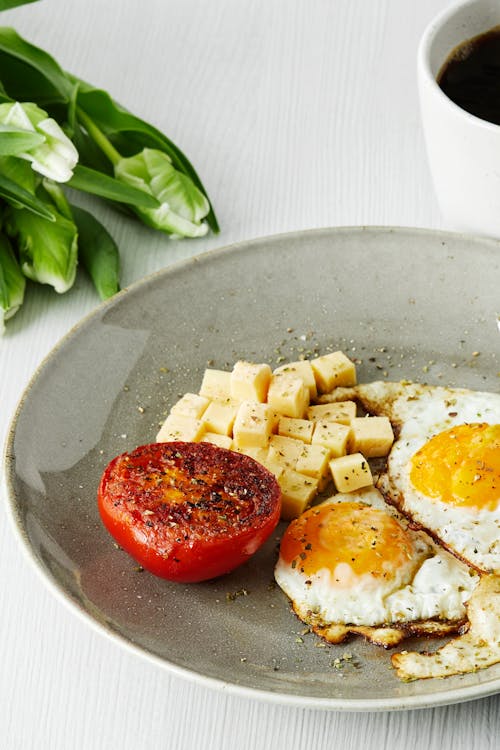 Keto breakfast with fried eggs, tomato and cheese