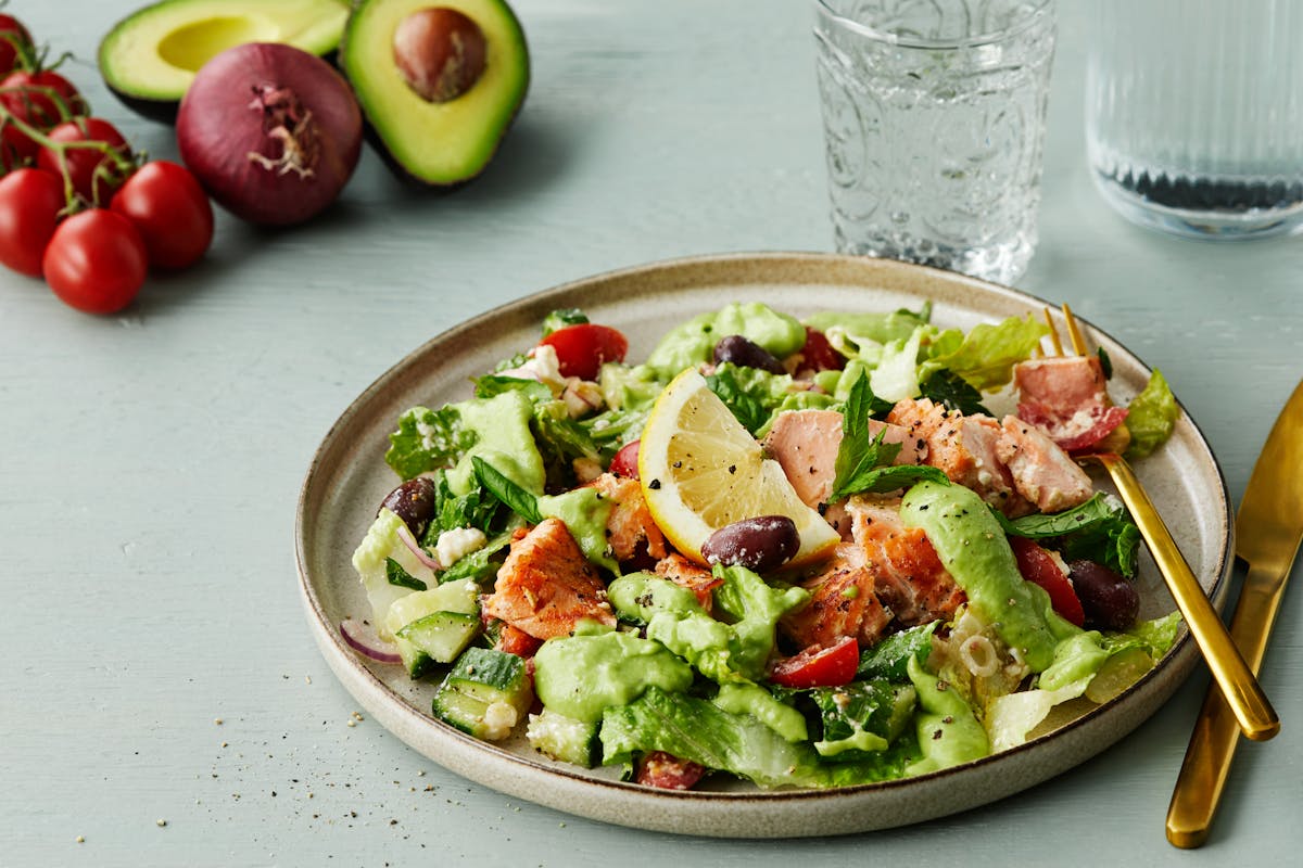 Salmon salad with feta cheese and avocado dressing