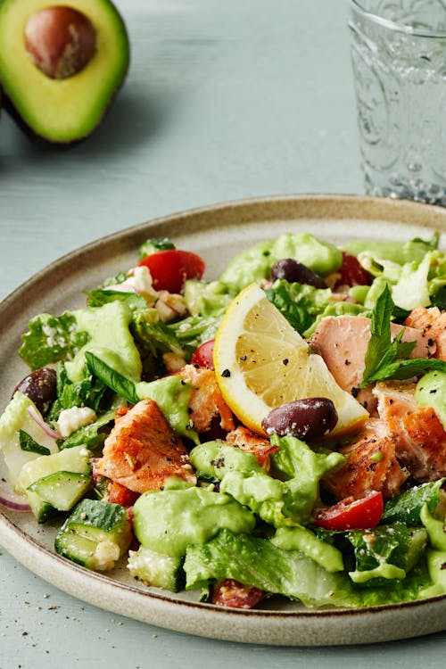 Salmon salad with feta cheese and avocado dressing