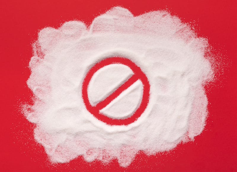 Stop prohibition sign on white sugar background