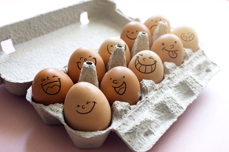 Funny drawing faces on eggs stock photo