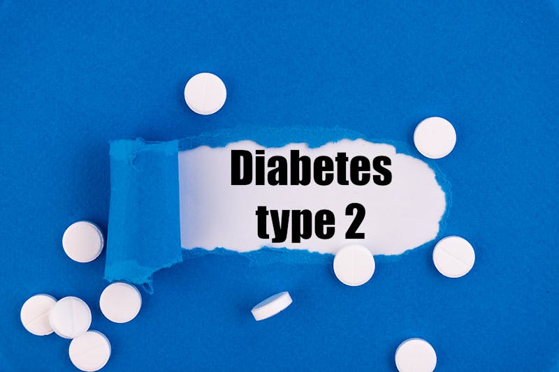 The text Diabetes type 2 appearing behind torn blue paper.