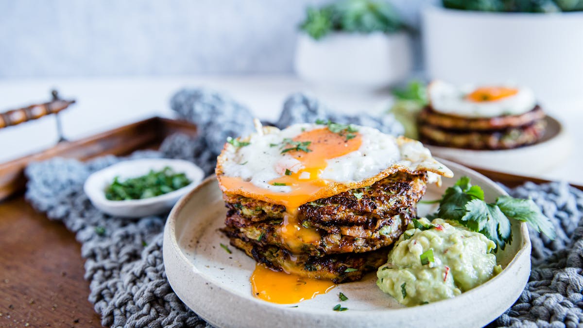 Zucchini bacon fritters with avocado mayo and crispy egg
