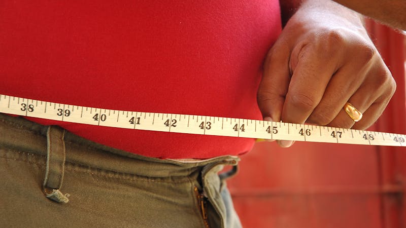A person measuring waist, Side view