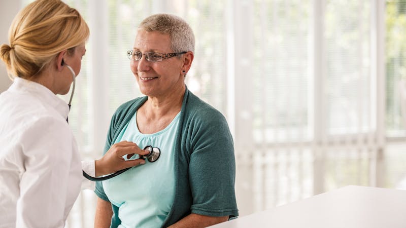 Doctor using stethoscope while examining patient